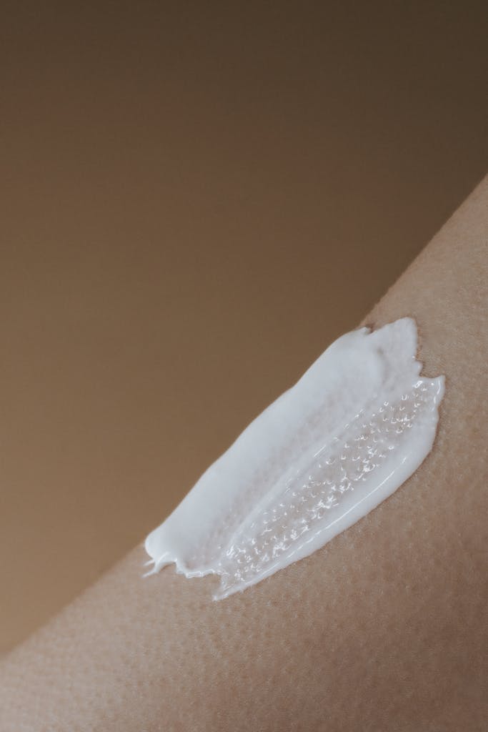 A detailed view of moisturizing cream applied on smooth human skin.