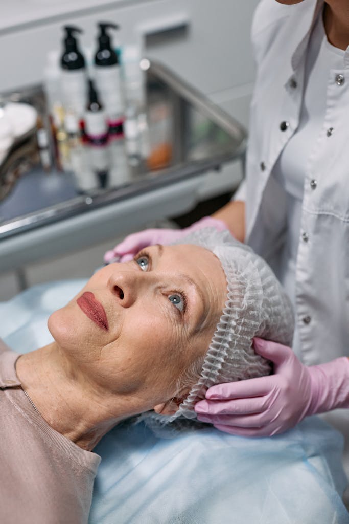 A senior woman undergoes a facial procedure at a medical clinic for rejuvenation.