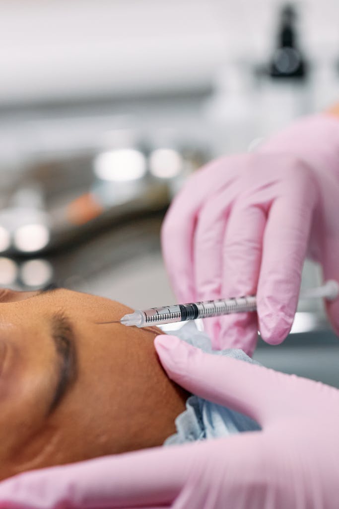 Detailed view of a cosmetic injection procedure being performed in a clinical setting.
